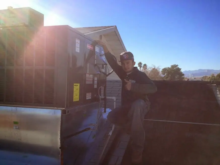HVAC technician performing Boiler Repair on a rooftop unit in Northlake